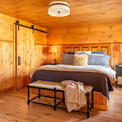 Custom barn doors for a closet designed to save space in a small bedroom. (Camp Ridlon)